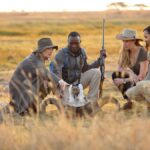 Are English-speaking safari guides available in Kenya and Tanzania?